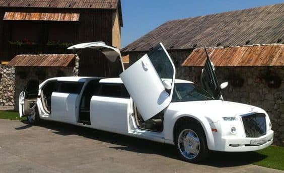 Limousine with Jet doors wide open and a green village set up
