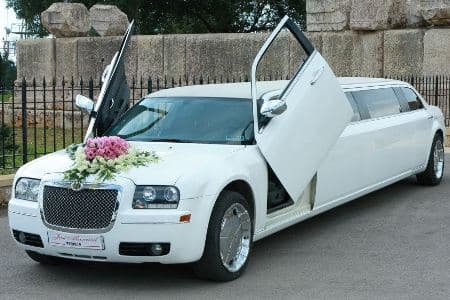 Regular chrysler white limousine decorated for bride