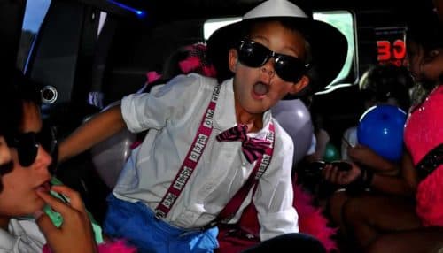 Kids dressed in special costumes in a limousine