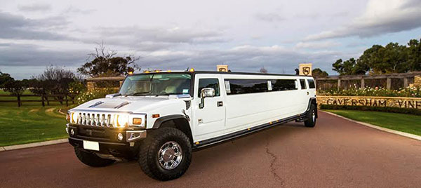 A white hummer limo pulling up to pick up for birthday